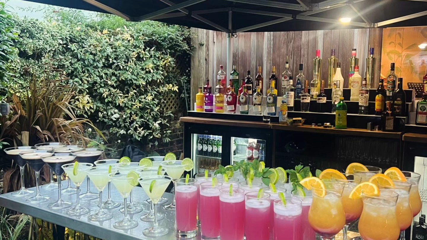 Mobile cocktail bar serving drinks at a London garden party