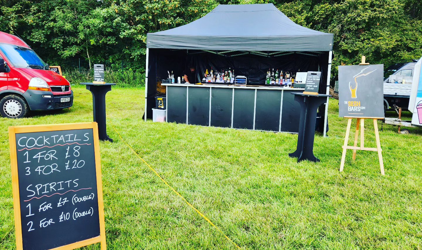 Mobile bar festival setup at an outdoor London event with The Sesh Bars crew