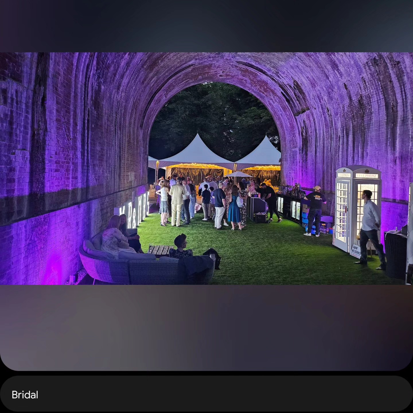 Wedding bar hire setup under a purple-lit viaduct venue in London