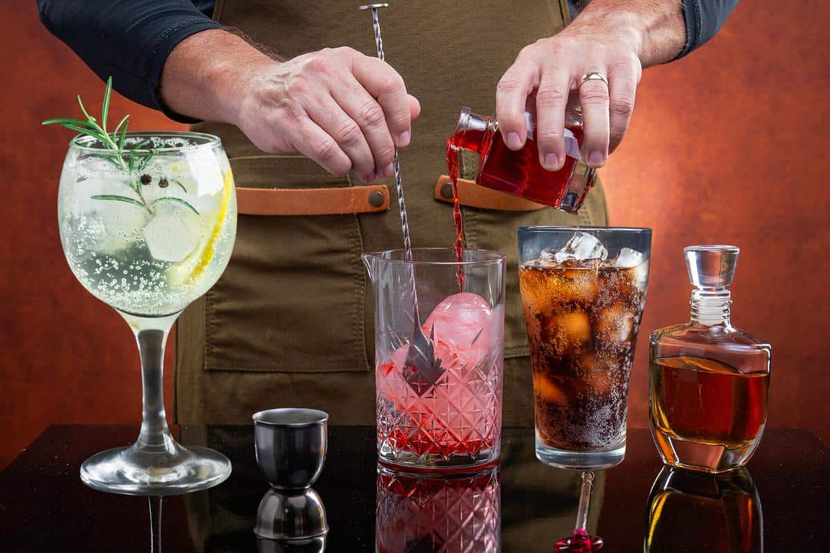 Colourful selection of expertly crafted cocktails being prepared at The Sesh Bars mobile bar hire event in London and Berkshire.