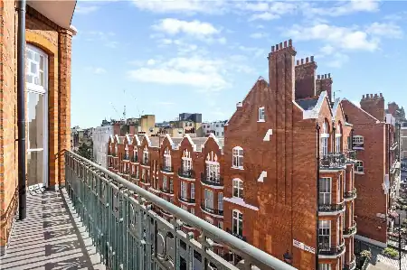 Balcony view of historic red brick buildings and Victorian architecture in central London showcasing The Sesh Bars mobile bar hire service.