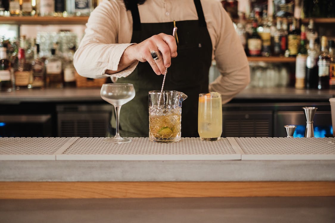Professional bartender preparing cocktails at a corporate event bar in London