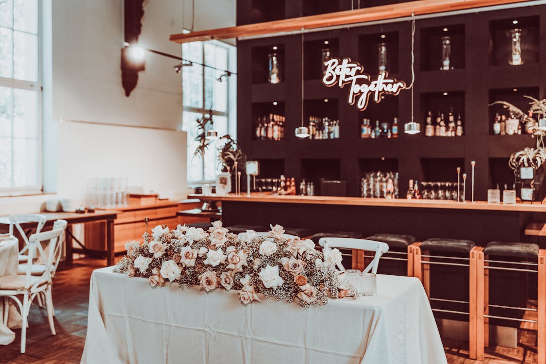 Elegant pop-up bar setup at a wedding venue with floral decorations