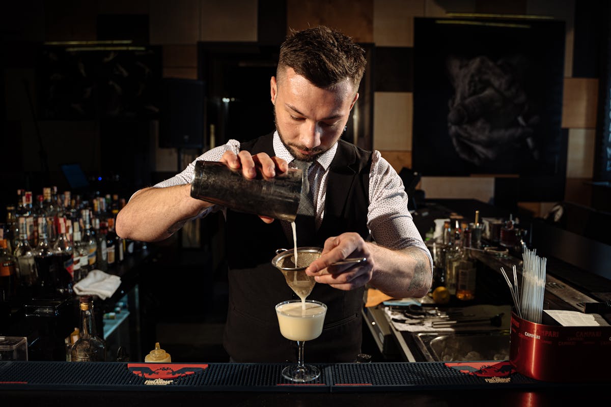 Professional bartender making cocktails at a London event